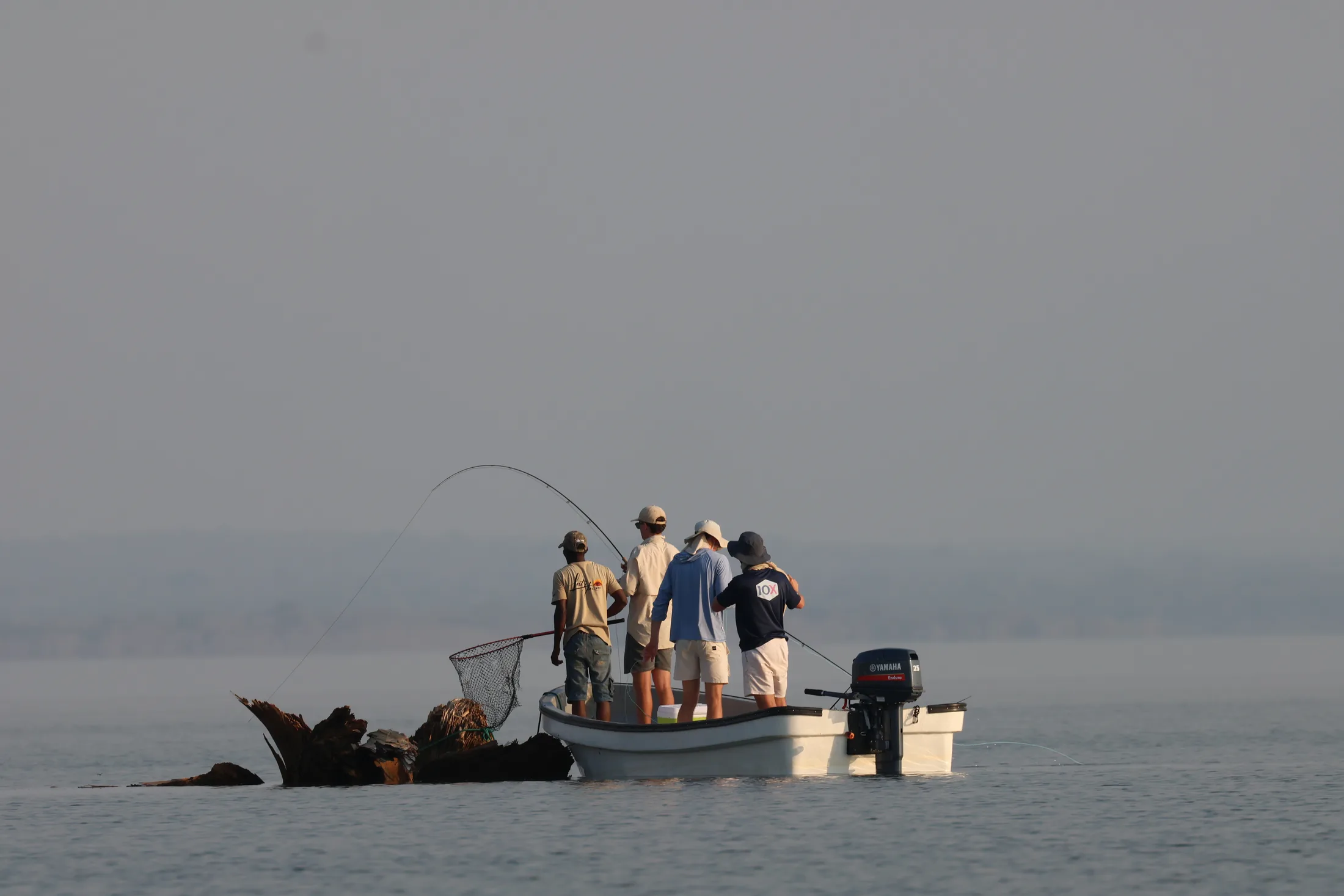 Guests tiger fishing from a boat on the lake at Shangaa
